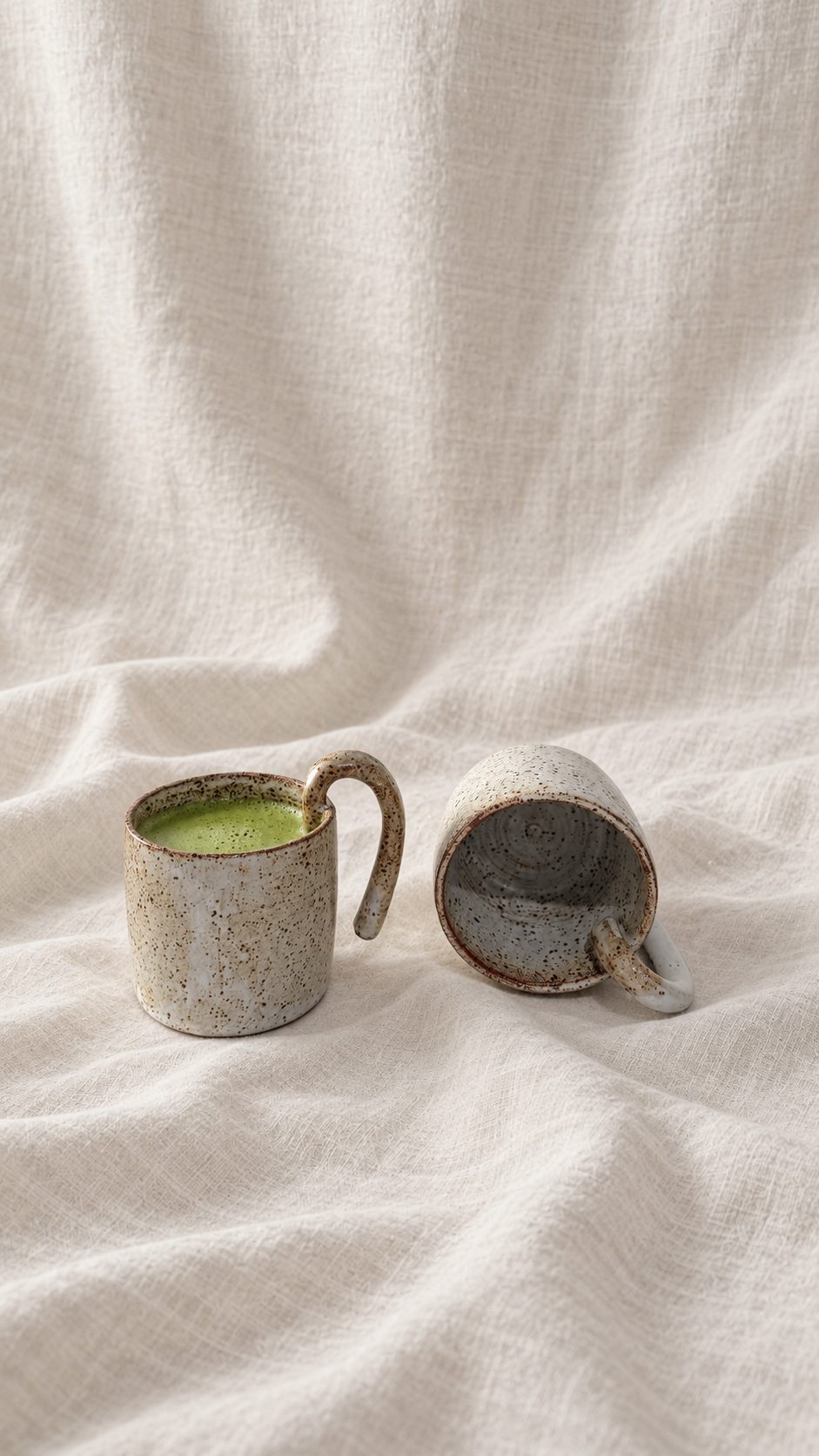 Aspen handmade ceramic mug with soft gray glaze, dark speckles, earthy brown rim and curved handle