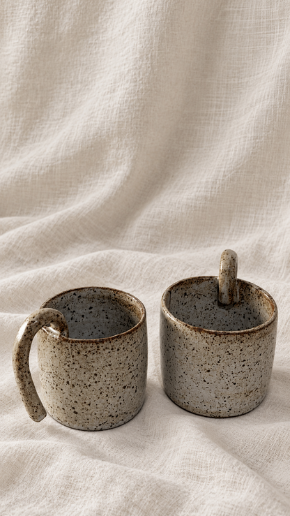 Aspen handmade ceramic mug with soft gray glaze, dark speckles, earthy brown rim and curved handle