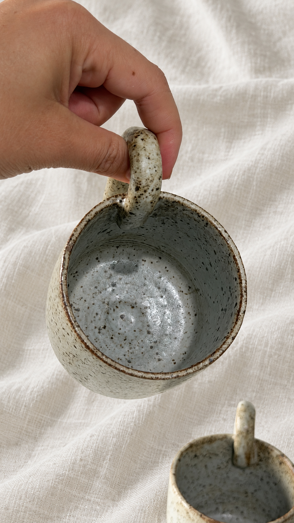 Aspen handmade ceramic mug with soft gray glaze, dark speckles, earthy brown rim and curved handle