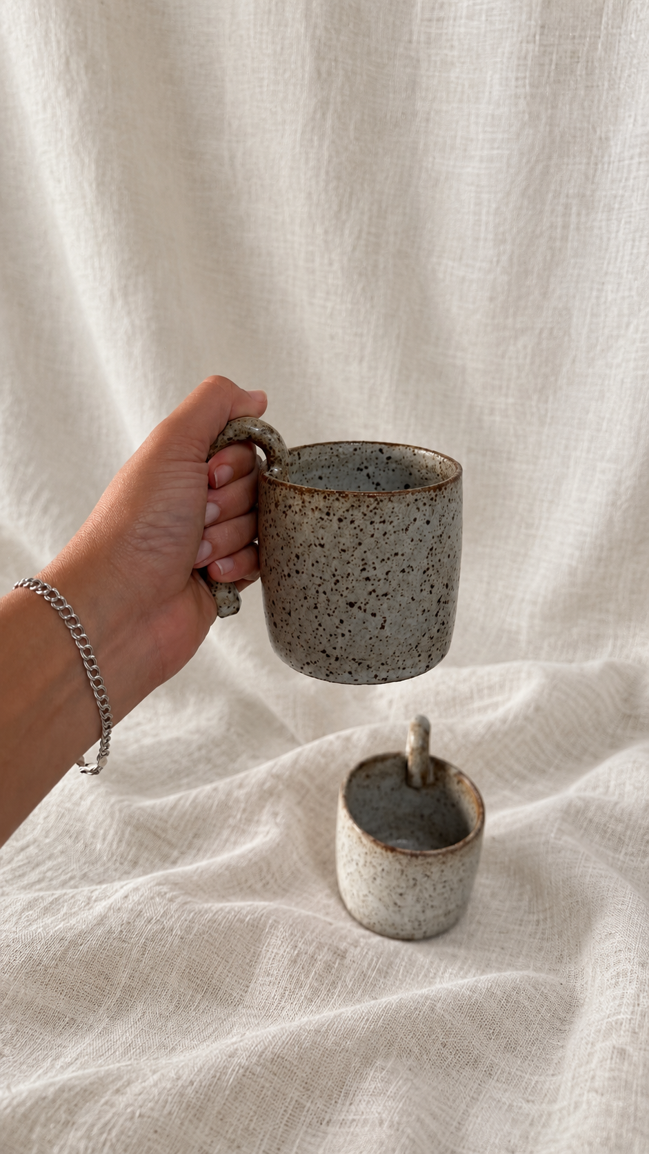 Aspen handmade ceramic mug with soft gray glaze, dark speckles, earthy brown rim and curved handle