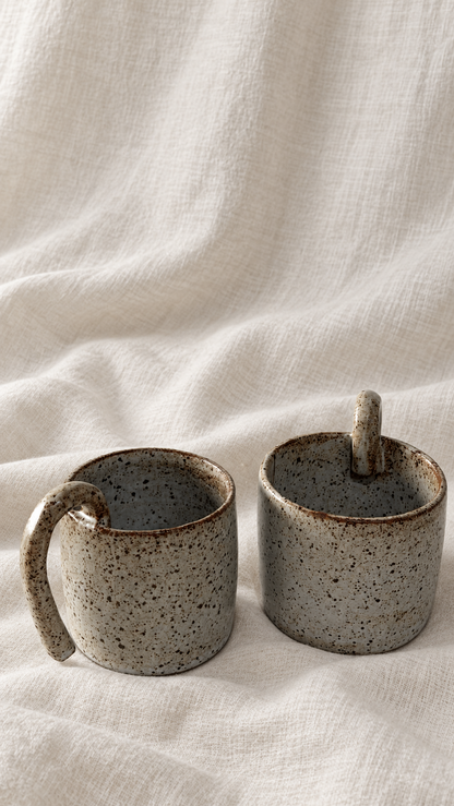 Aspen handmade ceramic mug with soft gray glaze, dark speckles, earthy brown rim and curved handle